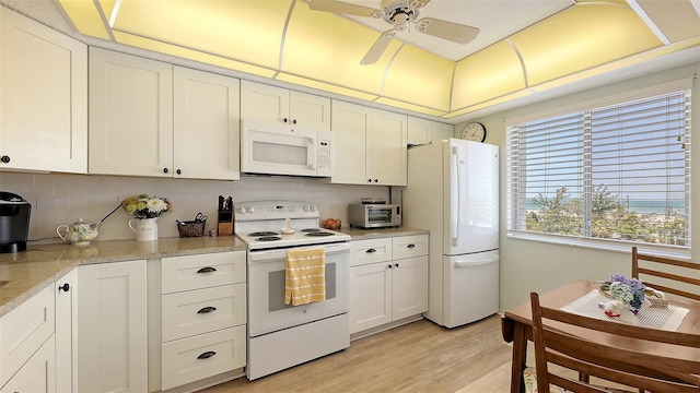 8897 Midnight Pass Rd Unit 407, Sarasota, FL 34242 - kitchen featuring white appliances, backsplash, light wood-style flooring, a ceiling fan, and light countertops