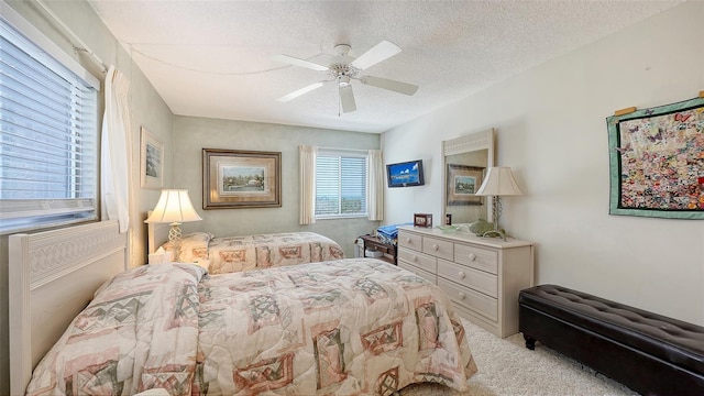 8897 Midnight Pass Rd Unit 407, Sarasota, FL 34242 - bedroom with a textured ceiling, carpet flooring, and ceiling fan