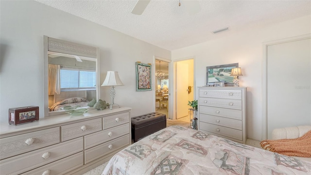 8897 Midnight Pass Rd Unit 407, Sarasota, FL 34242 - bedroom with carpet, ensuite bathroom, a textured ceiling, a chandelier, and ceiling fan