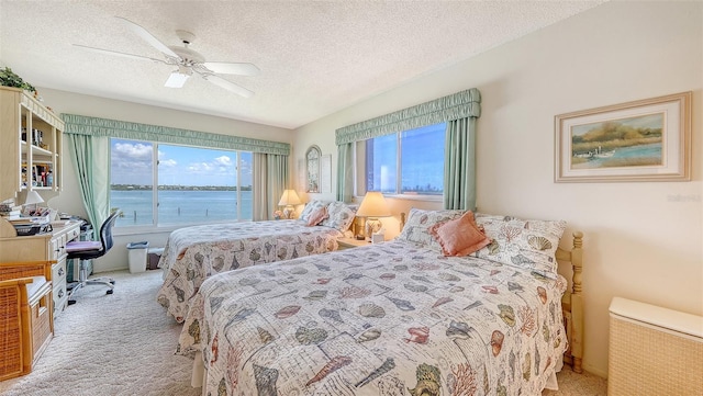 8897 Midnight Pass Rd Unit 407, Sarasota, FL 34242 - carpeted bedroom featuring a textured ceiling, a ceiling fan, and a water view