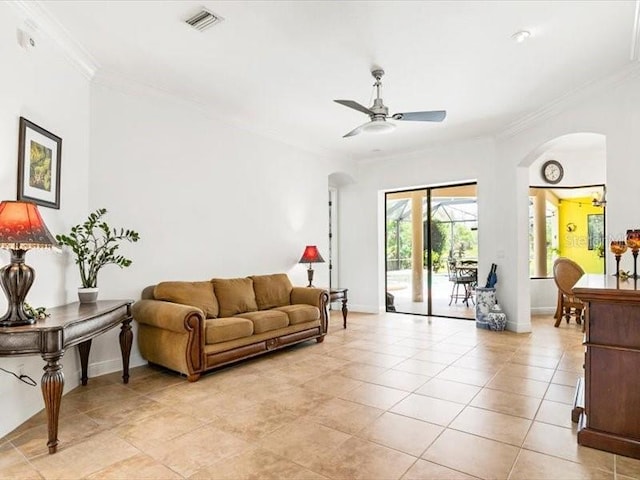312 148th Ct NE, Bradenton, FL 34212 - living room with arched walkways, crown molding, a ceiling fan, baseboards, and light tile patterned flooring