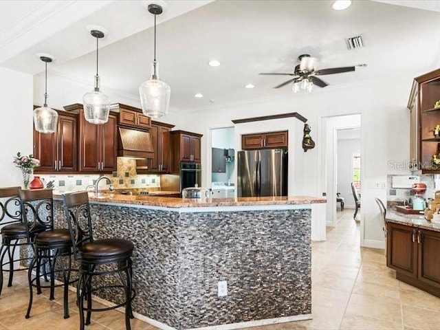 312 148th Ct NE, Bradenton, FL 34212 - kitchen with freestanding refrigerator, black oven, custom range hood, a peninsula, and backsplash