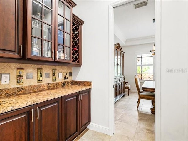 312 148th Ct NE, Bradenton, FL 34212 - bar area with baseboards, tasteful backsplash, crown molding, and light tile patterned floors