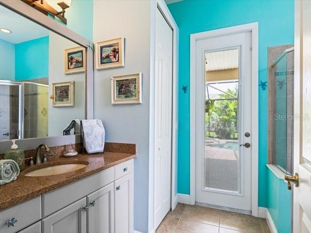 312 148th Ct NE, Bradenton, FL 34212 - full bathroom with vanity, a shower stall, tile patterned floors, and baseboards