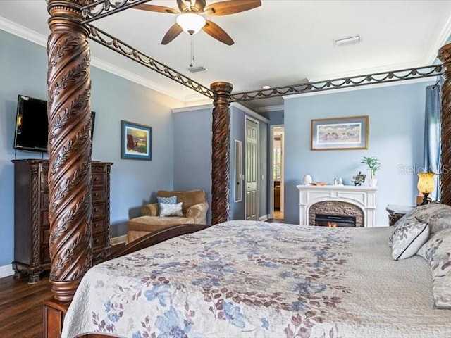 312 148th Ct NE, Bradenton, FL 34212 - bedroom with ornamental molding, wood finished floors, baseboards, a lit fireplace, and ceiling fan