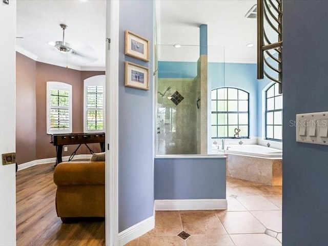 312 148th Ct NE, Bradenton, FL 34212 - ensuite bathroom with healthy amount of natural light, a garden tub, a walk in shower, baseboards, and ornamental molding