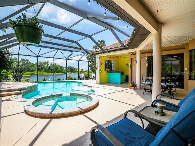 312 148th Ct NE, Bradenton, FL 34212 - view of pool featuring a patio, a pool with connected hot tub, a water view, and glass enclosure