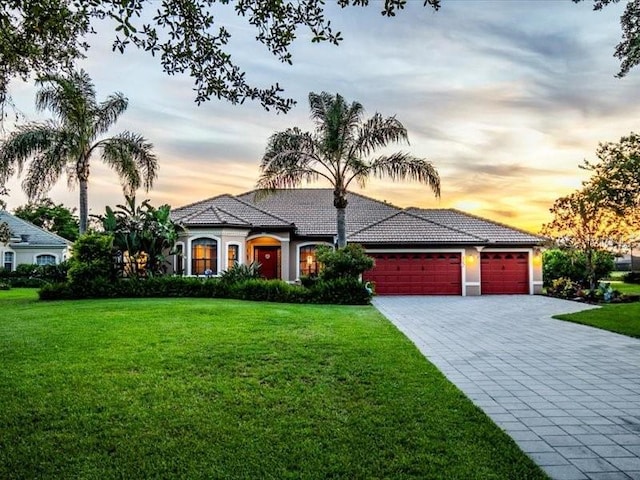 312 148th Ct NE, Bradenton, FL 34212 - view of front of house with decorative driveway, a front lawn, a garage, and a tiled roof