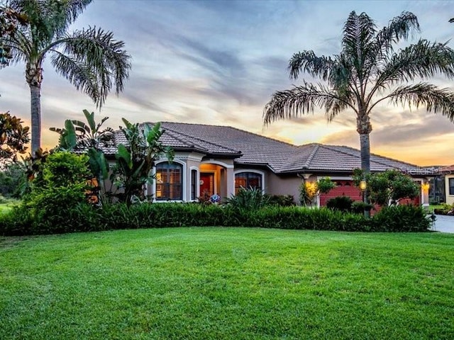 312 148th Ct NE, Bradenton, FL 34212 - view of front of house with a tile roof, a yard, and stucco siding