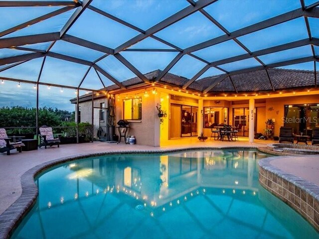 312 148th Ct NE, Bradenton, FL 34212 - view of pool featuring a patio area, glass enclosure, and a pool with connected hot tub