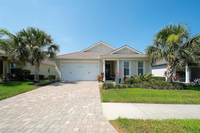 8077 Sandstar Way, Sarasota, FL 34240 - ranch-style house with a garage, decorative driveway, stucco siding, and a front lawn
