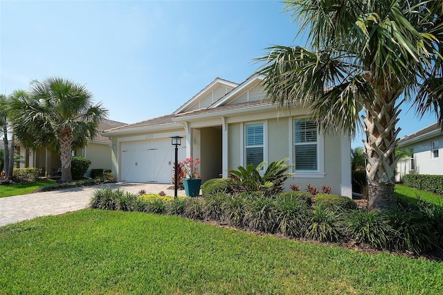 8077 Sandstar Way, Sarasota, FL 34240 - single story home featuring stucco siding, driveway, a garage, and a front lawn