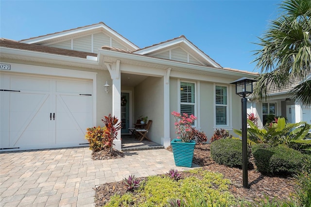 8077 Sandstar Way, Sarasota, FL 34240 - view of front of home with stucco siding, a garage, and driveway