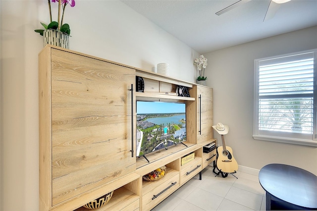 8077 Sandstar Way, Sarasota, FL 34240 - living area featuring light tile patterned floors, a ceiling fan, and baseboards