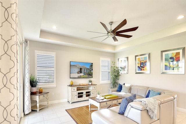 8077 Sandstar Way, Sarasota, FL 34240 - living area with ceiling fan, light tile patterned floors, baseboards, a tray ceiling, and recessed lighting