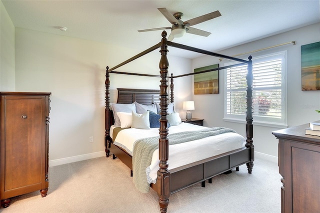 8077 Sandstar Way, Sarasota, FL 34240 - bedroom featuring light carpet, baseboards, and a ceiling fan