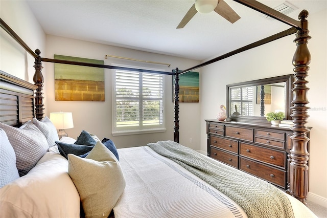 8077 Sandstar Way, Sarasota, FL 34240 - bedroom featuring multiple windows, ceiling fan, and baseboards