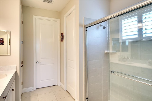 8077 Sandstar Way, Sarasota, FL 34240 - full bath with vanity, a shower stall, tile patterned floors, and baseboards