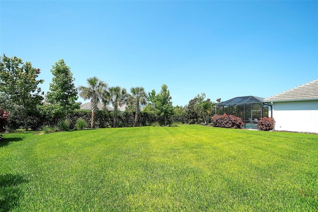 8077 Sandstar Way, Sarasota, FL 34240 - view of grassy yard with a lanai