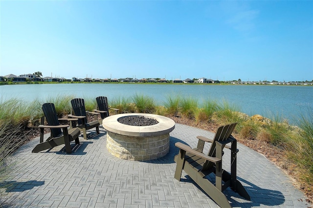 8077 Sandstar Way, Sarasota, FL 34240 - view of patio with an outdoor fire pit and a water view