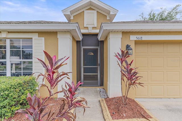 5618 Sheer Bliss Loop, Land O Lakes, FL 34639 - doorway to property with an attached garage, stucco siding, and driveway