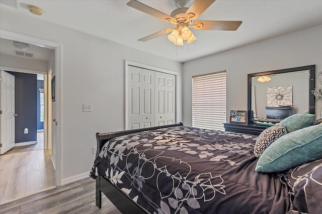 5618 Sheer Bliss Loop, Land O Lakes, FL 34639 - bedroom with baseboards, a closet, wood finished floors, and multiple windows