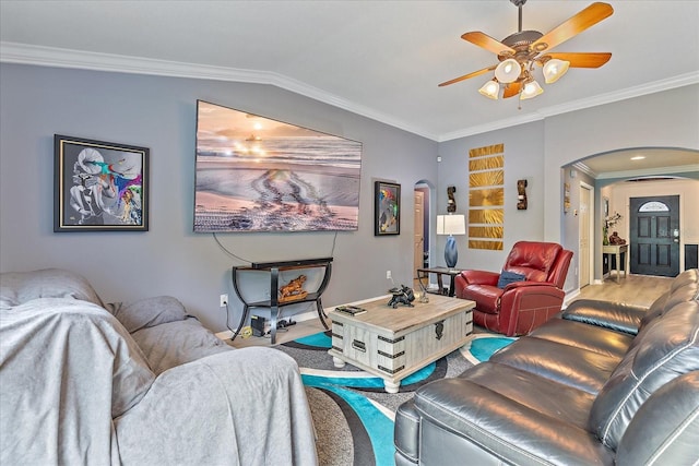 5618 Sheer Bliss Loop, Land O Lakes, FL 34639 - living room featuring arched walkways, a ceiling fan, crown molding, wood finished floors, and baseboards