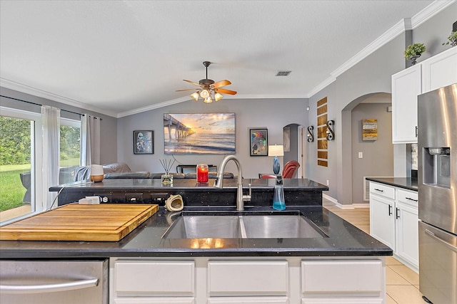 5618 Sheer Bliss Loop, Land O Lakes, FL 34639 - kitchen featuring appliances with stainless steel finishes, arched walkways, open floor plan, crown molding, and a ceiling fan