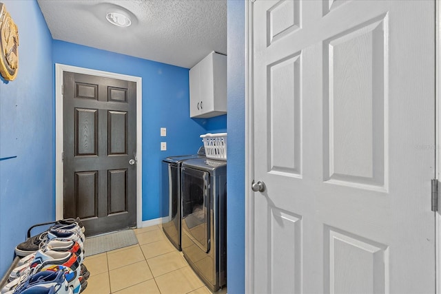 5618 Sheer Bliss Loop, Land O Lakes, FL 34639 - laundry room with washer and clothes dryer, cabinet space, light tile patterned flooring, and a textured ceiling
