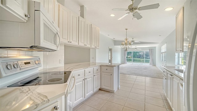 5566 Avellino Pl, Sarasota, FL 34238 - kitchen with white appliances, lofted ceiling, light tile patterned flooring, a chandelier, and light colored carpet