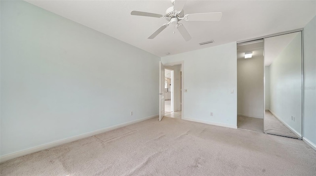 5566 Avellino Pl, Sarasota, FL 34238 - unfurnished bedroom with light colored carpet, a closet, baseboards, and a ceiling fan