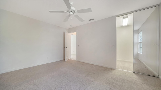 5566 Avellino Pl, Sarasota, FL 34238 - unfurnished bedroom with light colored carpet, baseboards, and a ceiling fan