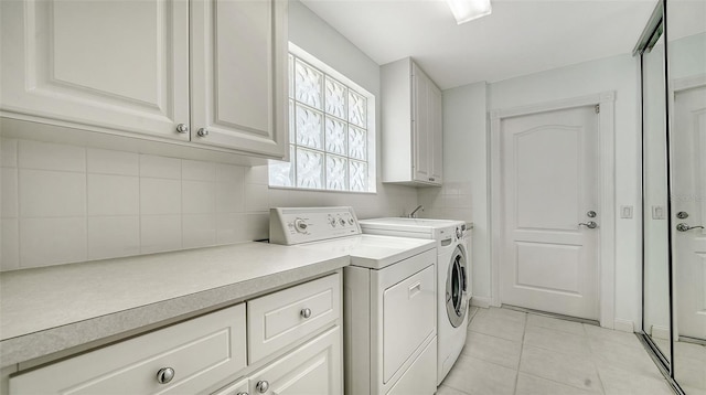 5566 Avellino Pl, Sarasota, FL 34238 - washroom with separate washer and dryer, cabinet space, and light tile patterned floors