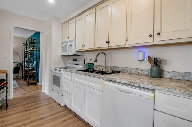 951 Varet Rd, Venice, FL 34293 - kitchen with white appliances, a sink, light countertops, light wood-style floors, and baseboards