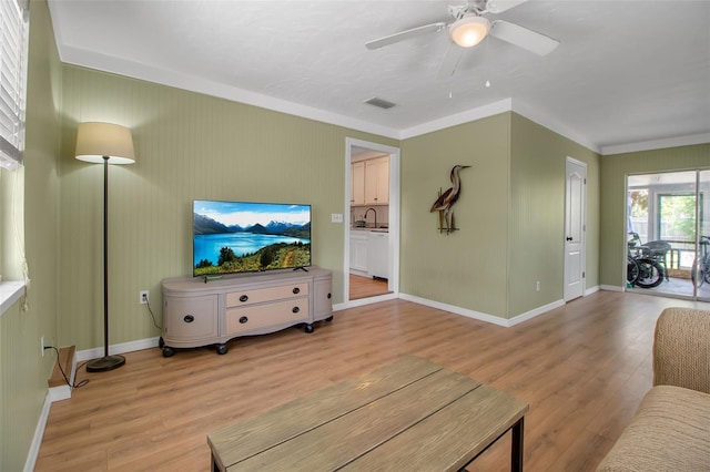 951 Varet Rd, Venice, FL 34293 - living room with light wood-type flooring, ceiling fan, baseboards, and ornamental molding