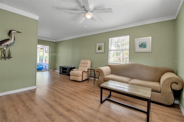 951 Varet Rd, Venice, FL 34293 - living area with crown molding, plenty of natural light, a ceiling fan, wood finished floors, and baseboards
