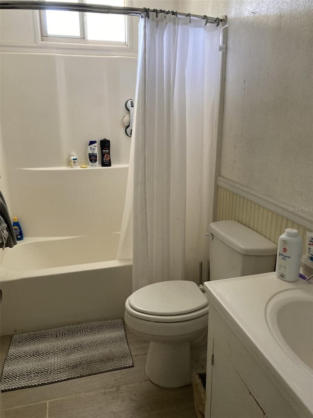 104 22nd Street Ct E, Bradenton, FL 34208 - full bath with toilet, shower / bath combo, vanity, wood finished floors, and wainscoting
