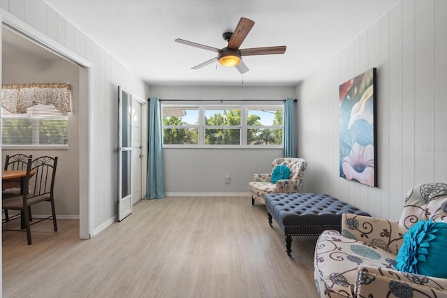 2503 Beneva Rd Unit 7, Sarasota, FL 34232 - sitting room with wood finished floors, ceiling fan, baseboards, and wooden walls