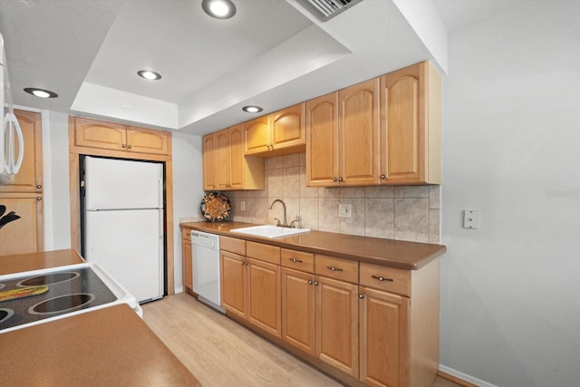 2503 Beneva Rd Unit 7, Sarasota, FL 34232 - kitchen featuring white appliances, a sink, light wood-style floors, decorative backsplash, and recessed lighting