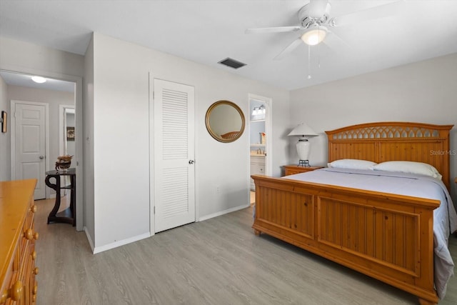 2503 Beneva Rd Unit 7, Sarasota, FL 34232 - bedroom with light wood finished floors, baseboards, ensuite bath, and a ceiling fan