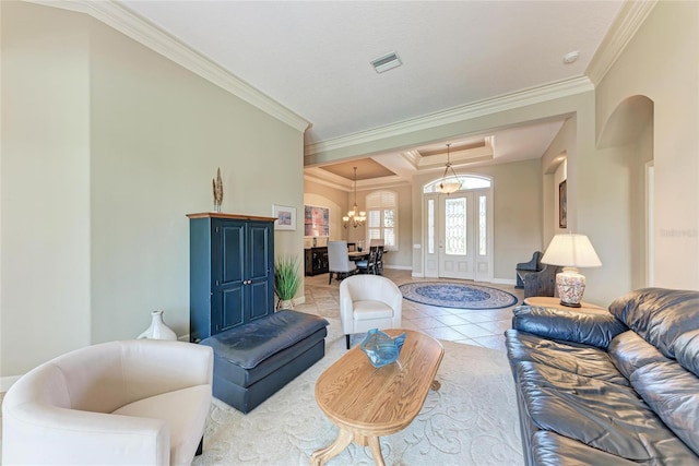 5205 88th St E, Bradenton, FL 34211 - tiled living area with arched walkways, ornamental molding, a chandelier, baseboards, and a tray ceiling