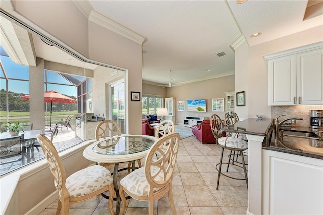 5205 88th St E, Bradenton, FL 34211 - dining space with ornamental molding, light tile patterned flooring, a sunroom, baseboards, and recessed lighting