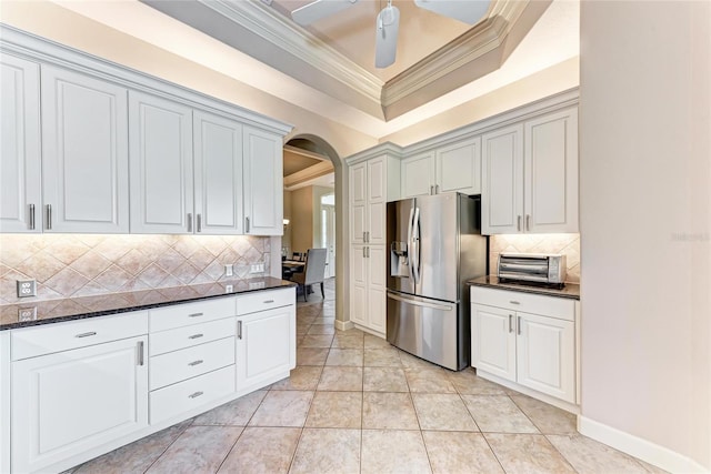 5205 88th St E, Bradenton, FL 34211 - kitchen featuring stainless steel refrigerator with ice dispenser, arched walkways, crown molding, tasteful backsplash, and a tray ceiling