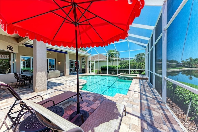5205 88th St E, Bradenton, FL 34211 - view of swimming pool featuring a patio area, a pool with connected hot tub, glass enclosure, and a water view