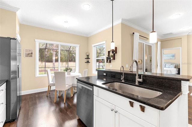 11794 Forest Park Cir, Bradenton, FL 34211 - kitchen with stainless steel appliances, a sink, dark wood finished floors, a center island with sink, and white cabinetry