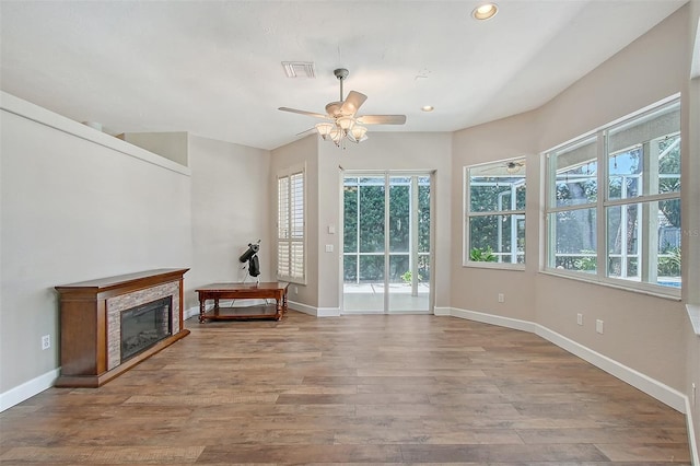 4603 4th Ave E, Bradenton, FL 34208 - unfurnished living room featuring ceiling fan, wood finished floors, recessed lighting, baseboards, and a glass covered fireplace