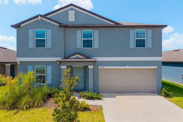 8656 40th Cir E, Palmetto, FL 34221 - view of front of property featuring concrete driveway, an attached garage, and stucco siding