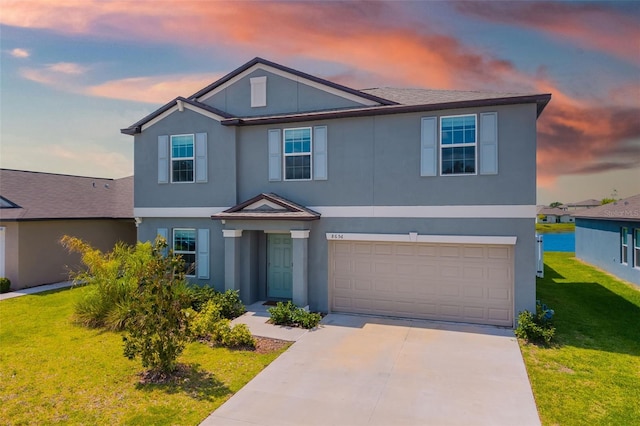 8656 40th Cir E, Palmetto, FL 34221 - view of front of property with a garage, driveway, a front yard, and stucco siding