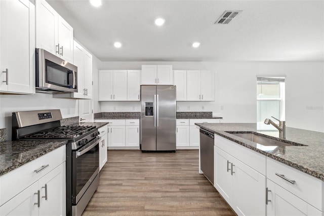 8656 40th Cir E, Palmetto, FL 34221 - kitchen featuring appliances with stainless steel finishes, a sink, recessed lighting, light wood-style floors, and white cabinetry