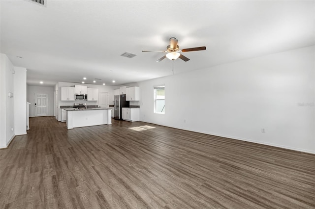 8656 40th Cir E, Palmetto, FL 34221 - unfurnished living room featuring ceiling fan, recessed lighting, dark wood-type flooring, and baseboards